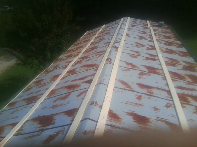 Rusted metal roof panels with new wood purlins before replacement — Storm Damage Roof Repair in Killeen by Roofing Brothers